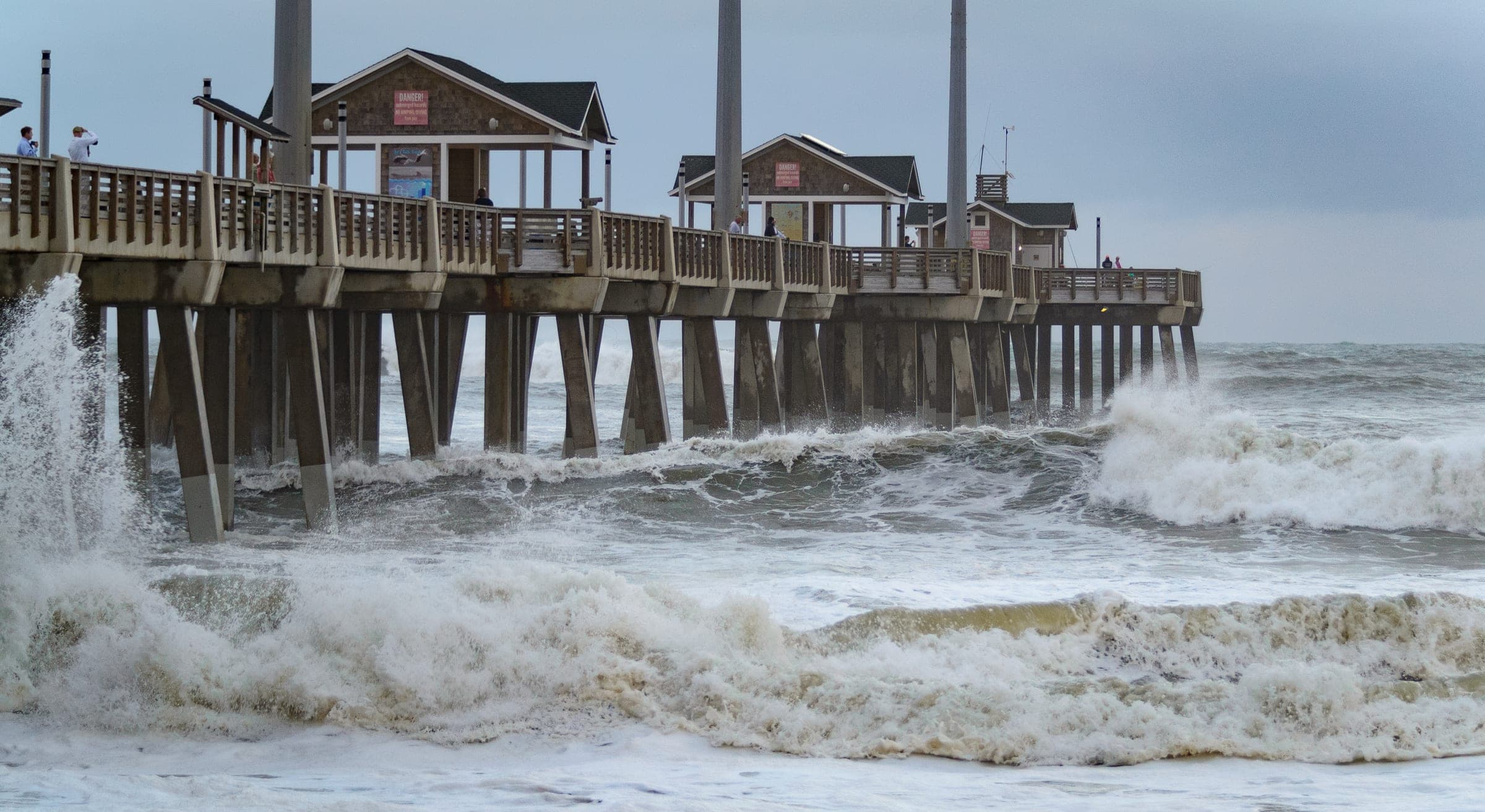 Storm surf crashing against the pilings of an ocean fishing pier