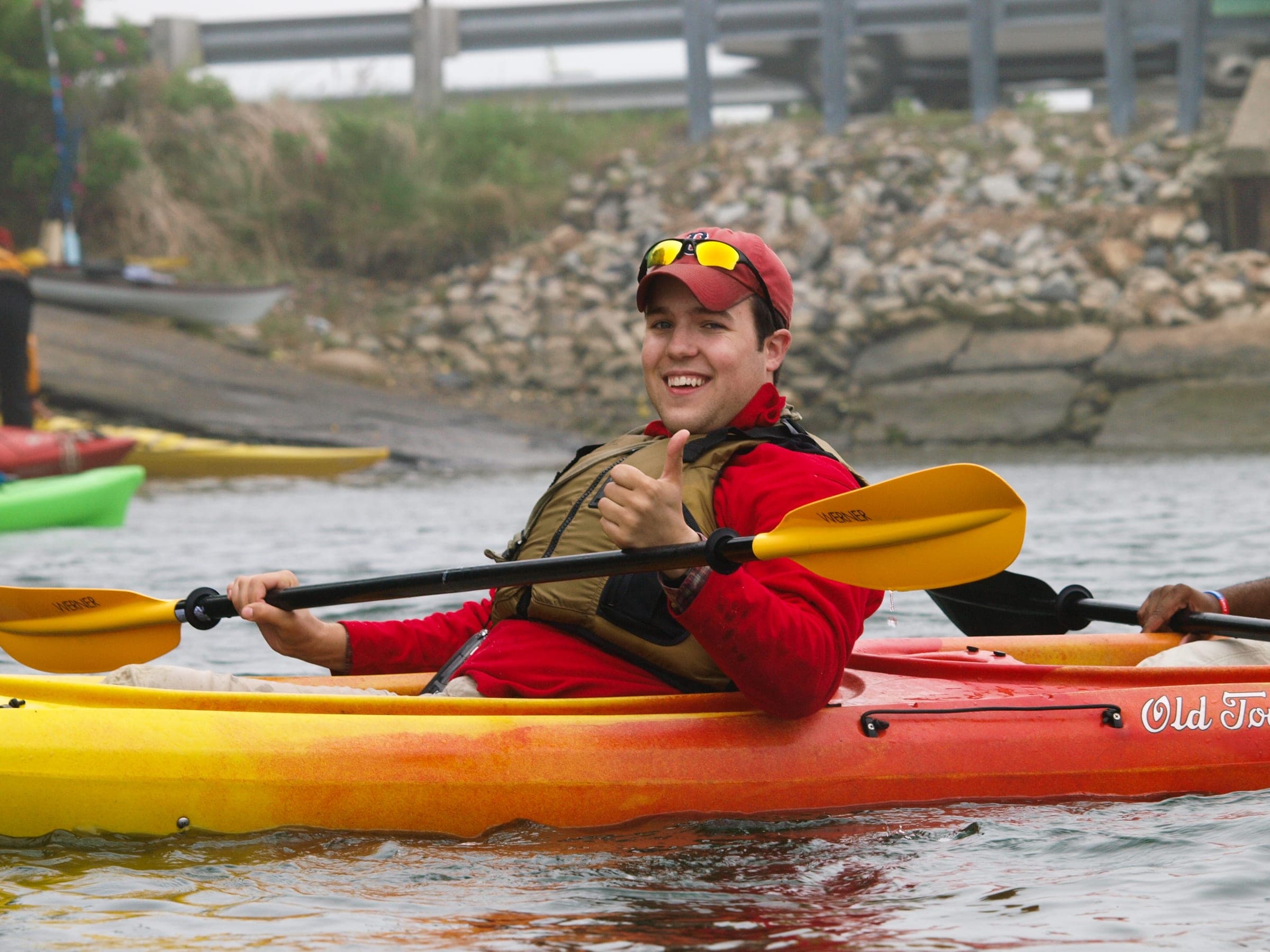 A kayaker paddling on calm marsh water