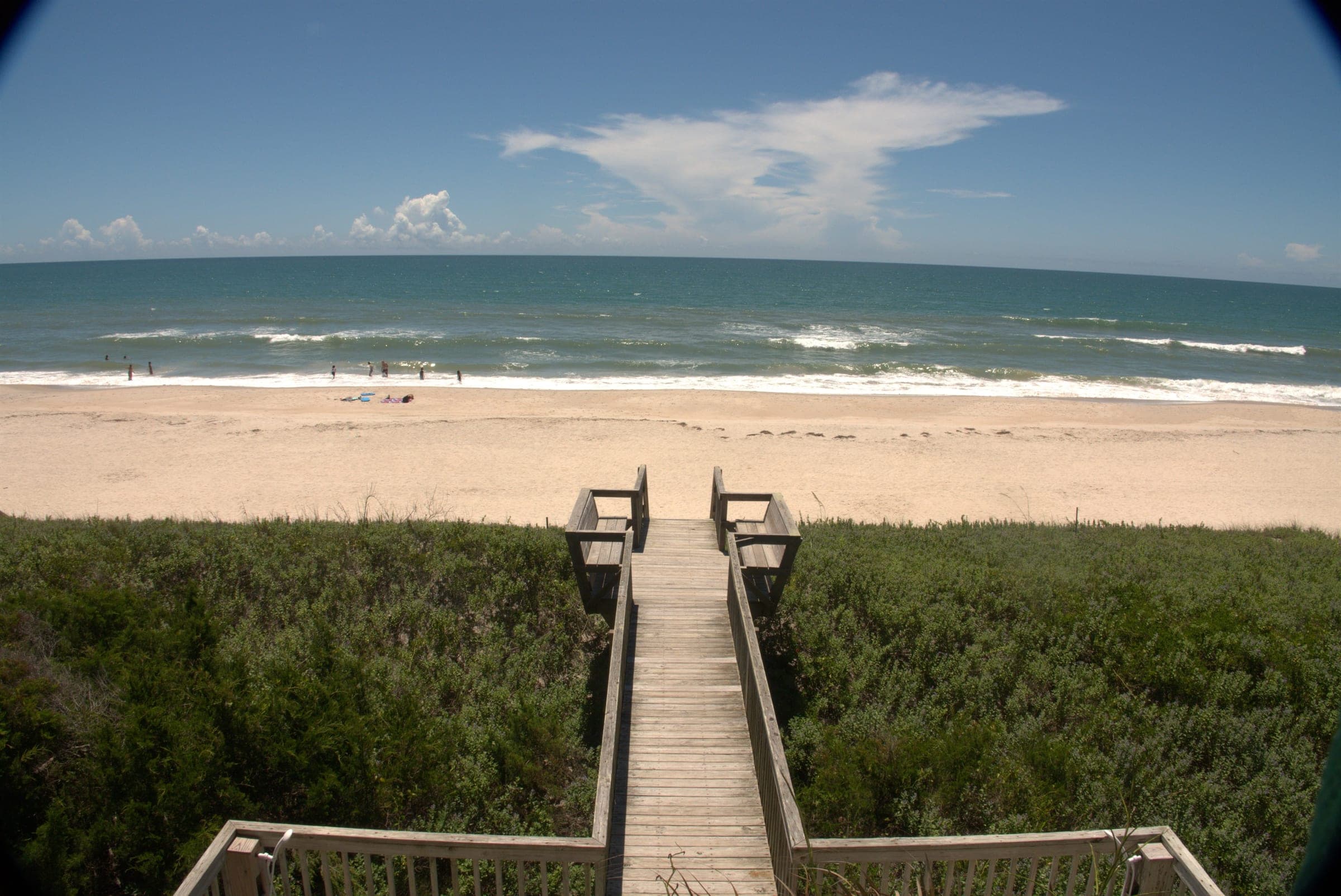 Two chairs by a private walkway and an empty stretch of North Topsail Beach